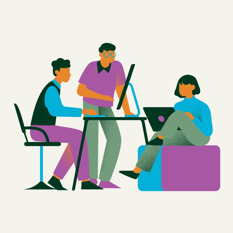 student sits with laptop on pouf. two tutors sit at table behind laptop. 